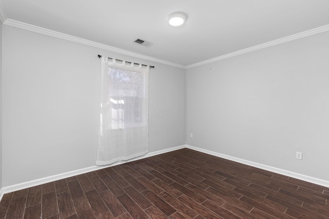 spare room featuring ornamental molding and dark hardwood / wood-style flooring