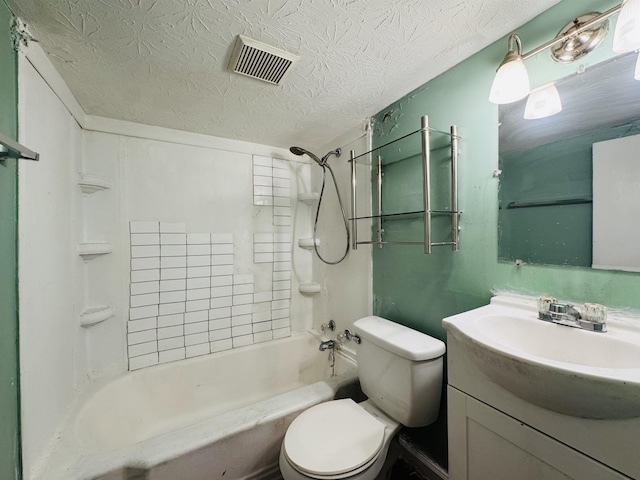 full bathroom featuring a textured ceiling, vanity, toilet, and tiled shower / bath