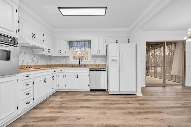 kitchen with crown molding, stainless steel appliances, sink, and white cabinets