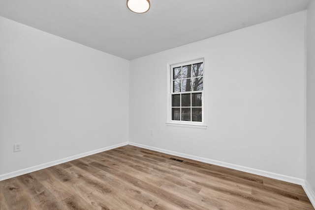 unfurnished room with hardwood / wood-style floors