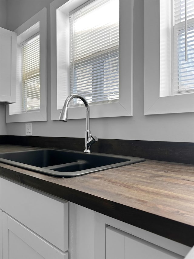 room details featuring white cabinetry and sink