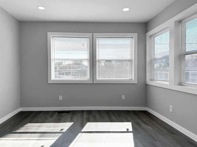 unfurnished room featuring dark wood-type flooring