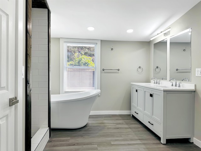 bathroom featuring a bathtub, vanity, and wood-type flooring