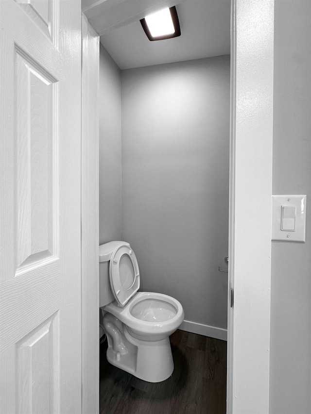 bathroom featuring toilet and wood-type flooring