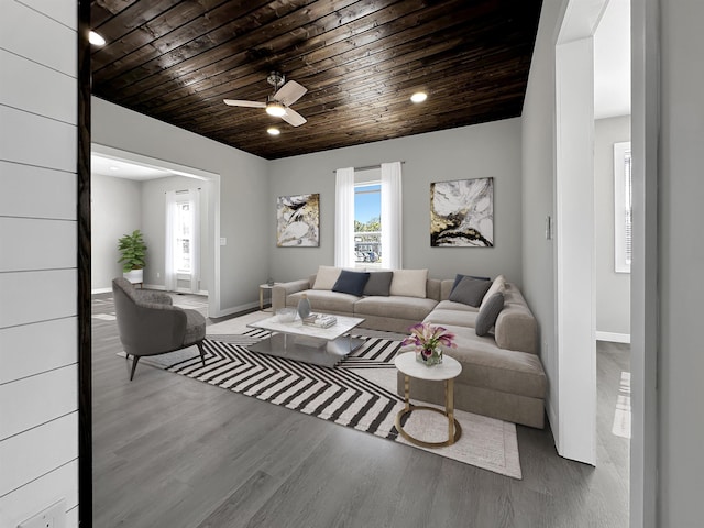 living room with hardwood / wood-style floors, ceiling fan, and wood ceiling