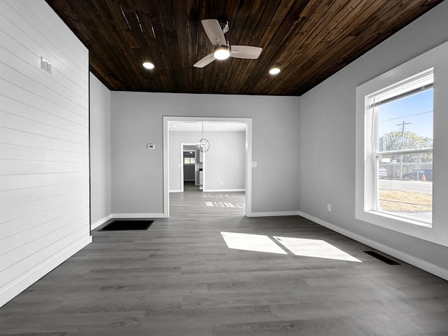 spare room featuring ceiling fan with notable chandelier, wood-type flooring, and wood ceiling