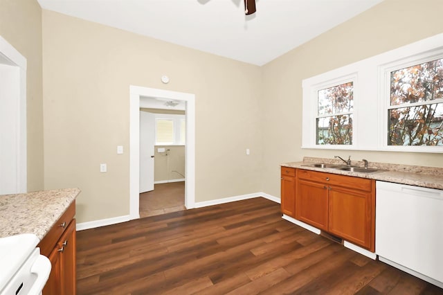 kitchen featuring a sink, dishwasher, dark wood finished floors, brown cabinets, and baseboards