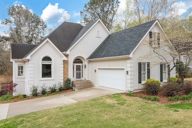 view of front of home with a front yard and a garage