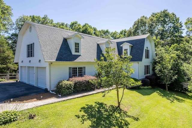 view of front of house featuring a garage and a front lawn