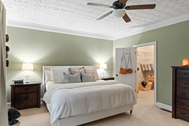 carpeted bedroom featuring ceiling fan, crown molding, and a textured ceiling