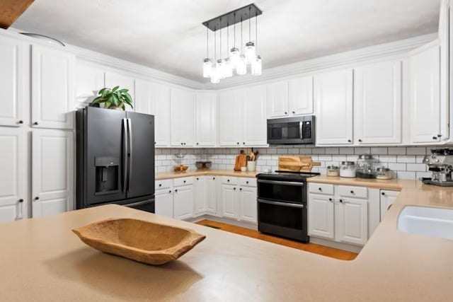 kitchen with tasteful backsplash, stainless steel appliances, hanging light fixtures, and white cabinets