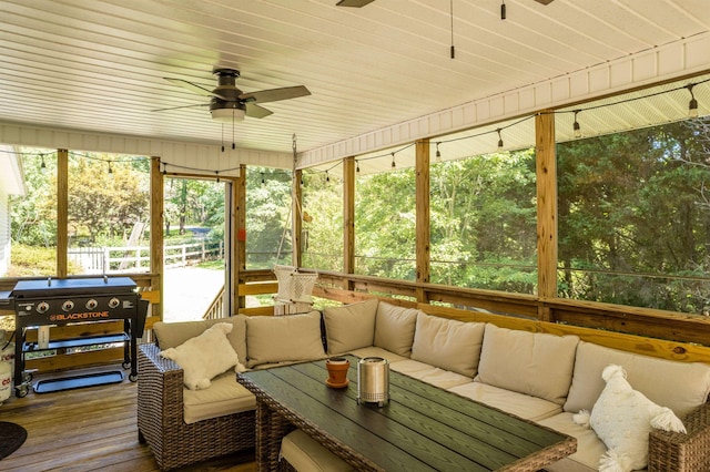 sunroom / solarium featuring ceiling fan