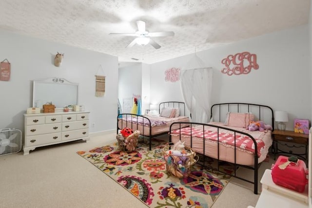 bedroom featuring ceiling fan, light colored carpet, and a textured ceiling