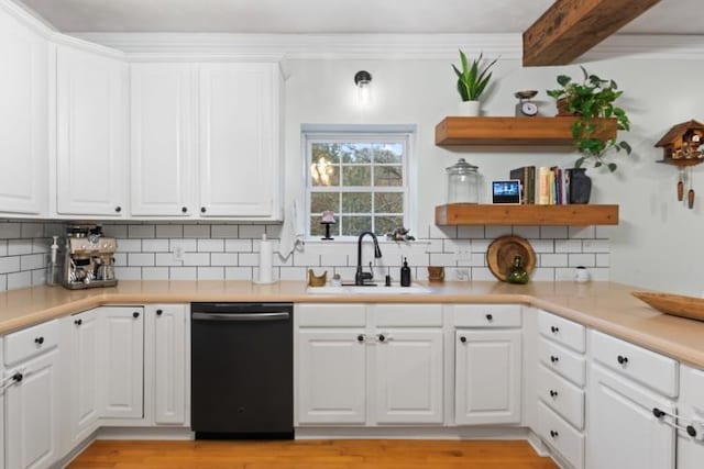 kitchen with backsplash, black dishwasher, sink, and white cabinets