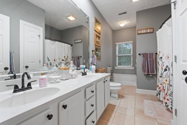 bathroom featuring a shower with curtain, vanity, tile patterned floors, and toilet