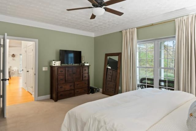 carpeted bedroom with crown molding and ceiling fan