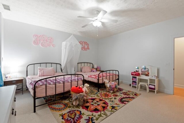 playroom with ceiling fan and a textured ceiling