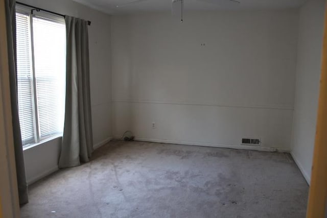 empty room with a healthy amount of sunlight and light carpet