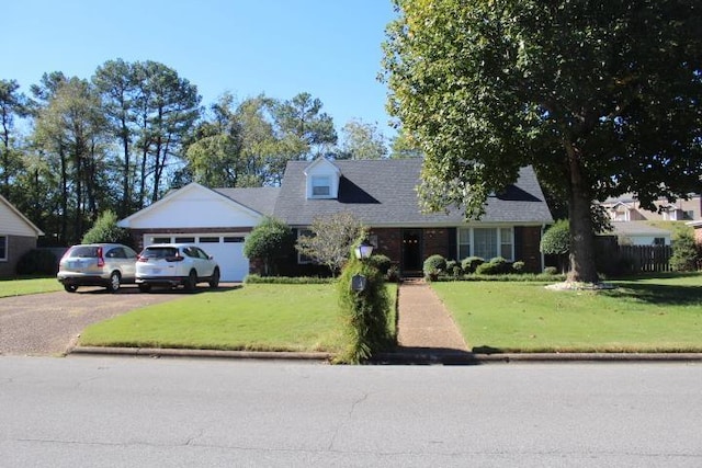 view of front of property featuring a front lawn and a garage