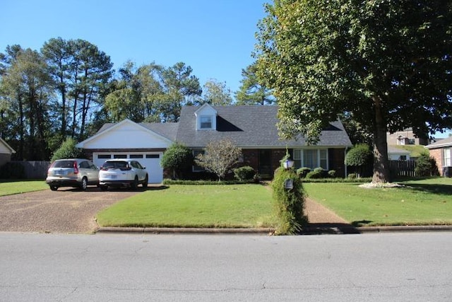 view of front of house with a garage and a front lawn