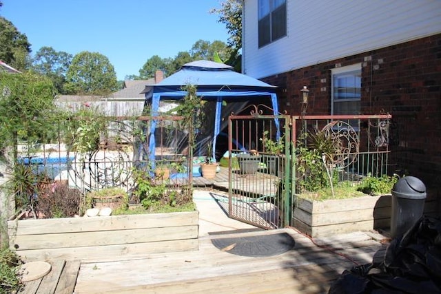 wooden terrace featuring a gazebo