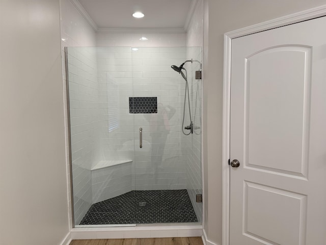 bathroom featuring a shower with shower door and hardwood / wood-style floors