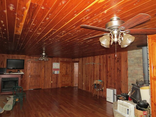 interior space featuring wood walls, dark hardwood / wood-style flooring, wooden ceiling, and a fireplace