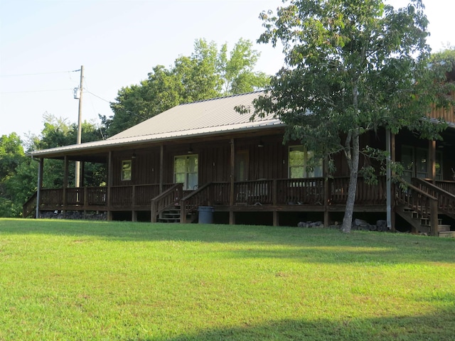 rear view of property with a yard