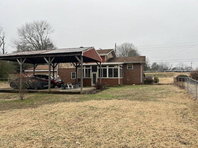  - rear view of house featuring brick siding and a carport