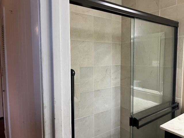  - bathroom featuring a shower stall and vanity