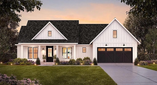 view of front of home with a yard and a garage