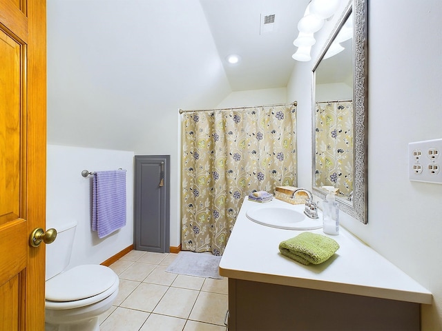 bathroom featuring vanity, tile patterned floors, vaulted ceiling, toilet, and walk in shower