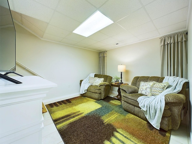 tiled living room featuring a paneled ceiling