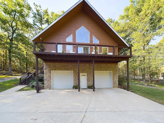 view of side of home with a balcony and a garage