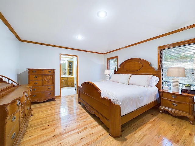 bedroom featuring ensuite bathroom, crown molding, and light hardwood / wood-style floors