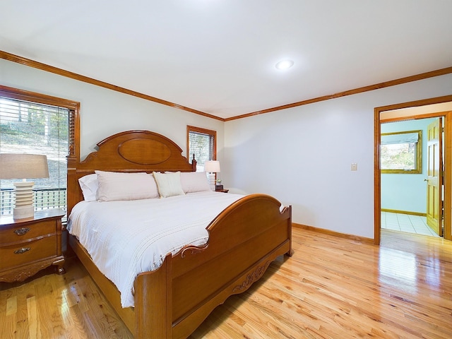 bedroom with light hardwood / wood-style flooring and crown molding