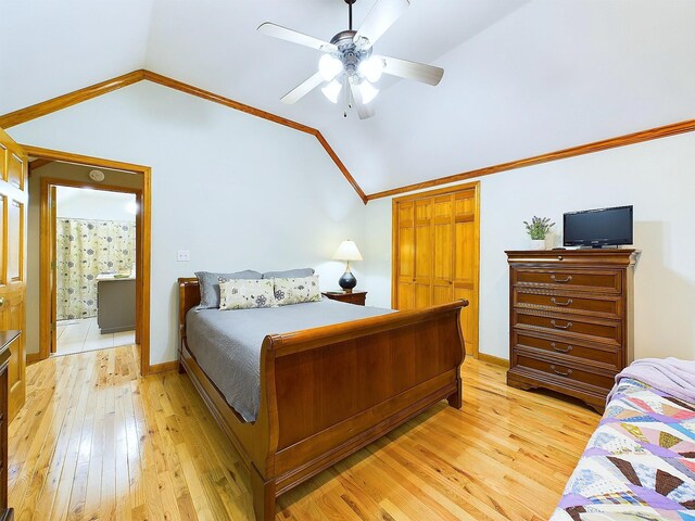 bedroom with vaulted ceiling, ceiling fan, crown molding, light hardwood / wood-style flooring, and a closet