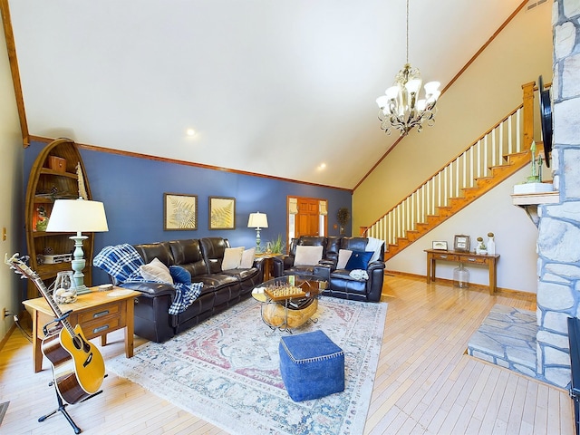 living room featuring hardwood / wood-style flooring, a notable chandelier, crown molding, and vaulted ceiling