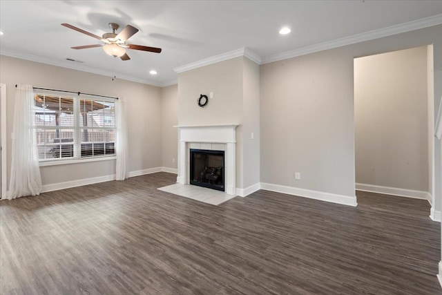 unfurnished living room with dark hardwood / wood-style floors, ceiling fan, ornamental molding, and a tile fireplace