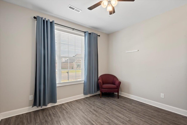 unfurnished room with dark hardwood / wood-style floors, ceiling fan, and a healthy amount of sunlight