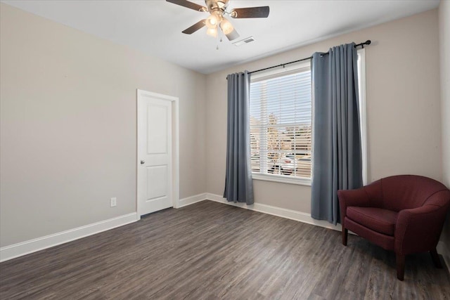 living area with dark hardwood / wood-style floors and ceiling fan