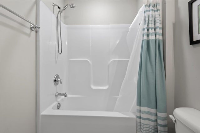 bathroom featuring shower / bath combo and toilet