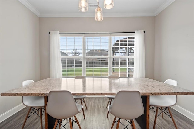 dining room featuring hardwood / wood-style flooring and ornamental molding