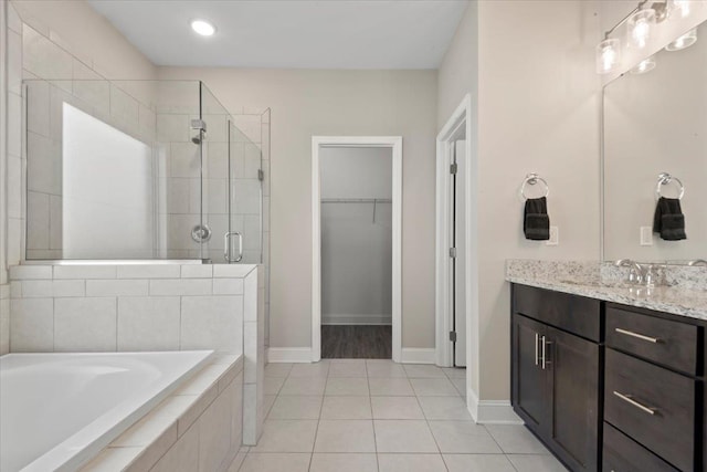 bathroom featuring tile patterned flooring, vanity, and separate shower and tub