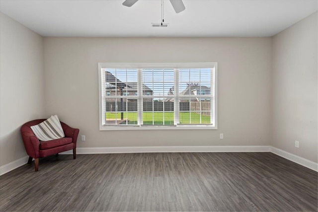 unfurnished room with ceiling fan and dark wood-type flooring