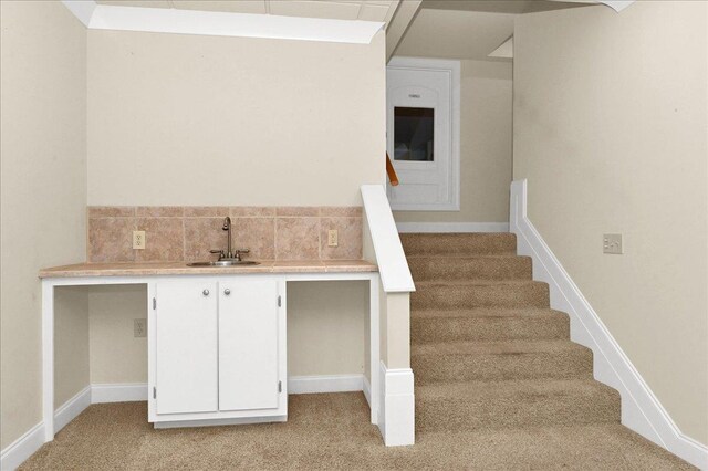 stairway with carpet and sink