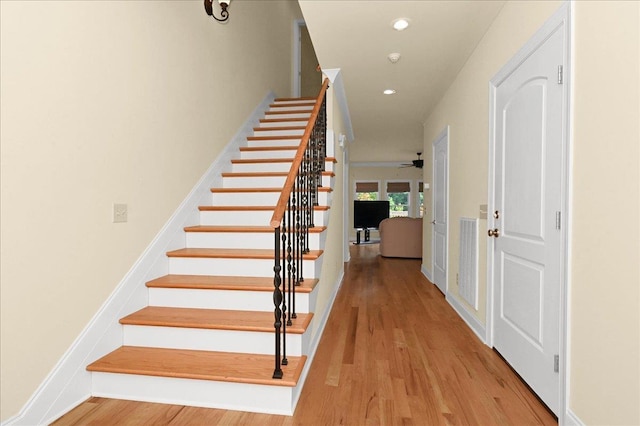 stairs featuring wood-type flooring