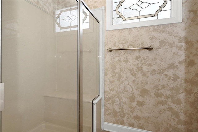 bathroom with plenty of natural light and walk in shower