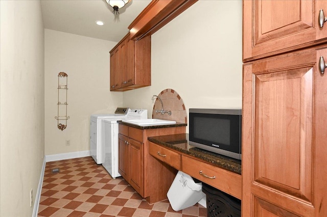 laundry area with washing machine and dryer and cabinets
