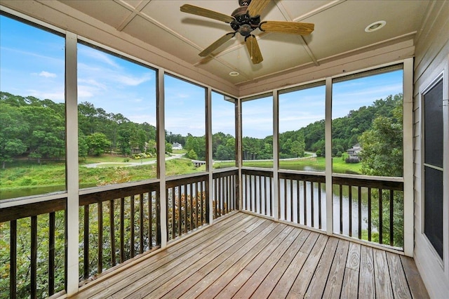 unfurnished sunroom featuring a healthy amount of sunlight and ceiling fan